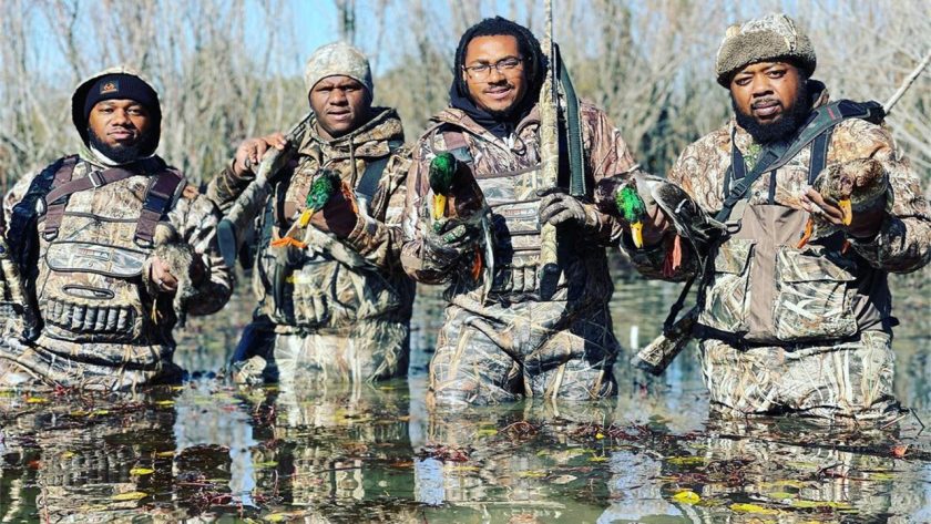 A group of men returning from hunting in winter with a full load.