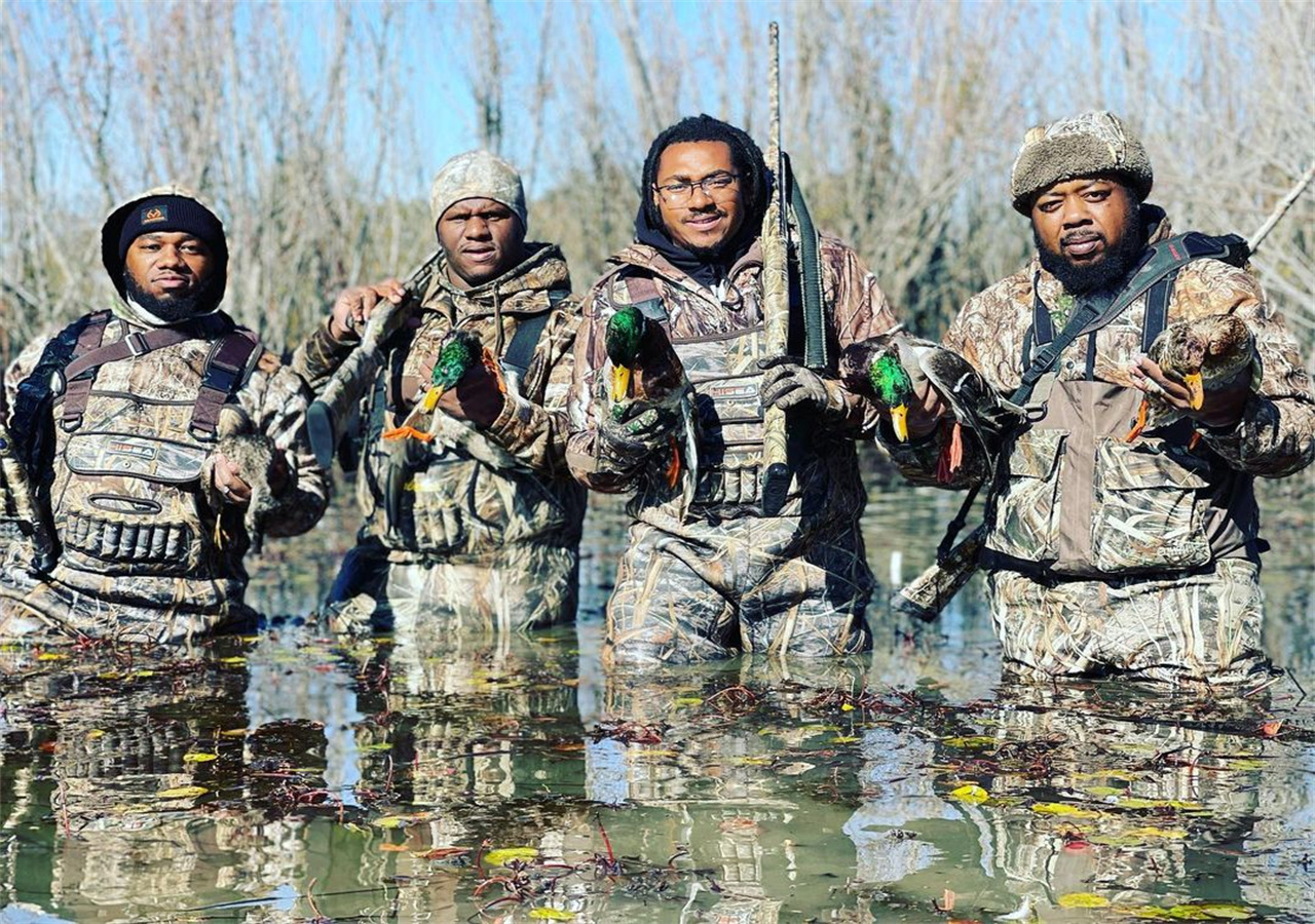 A group of men returning from hunting in winter with a full load.