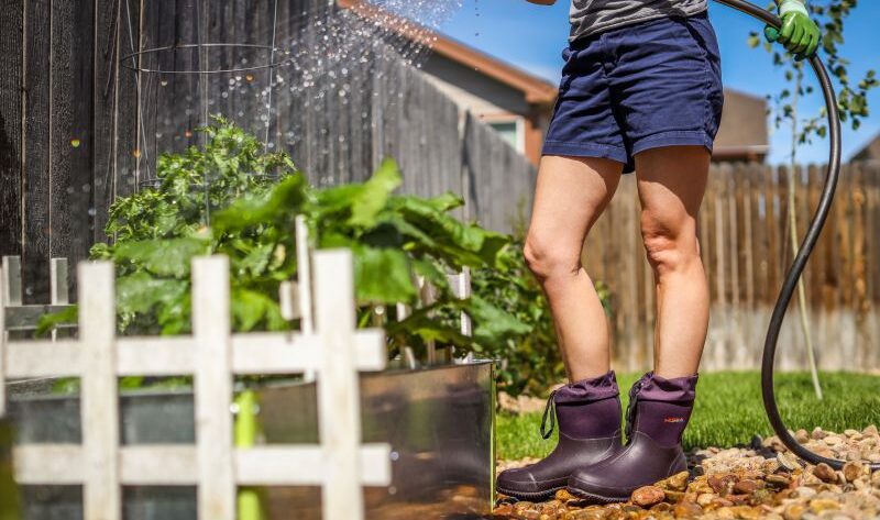 women standing in the yard wearing a pair of HISEA boots, doing gardening work